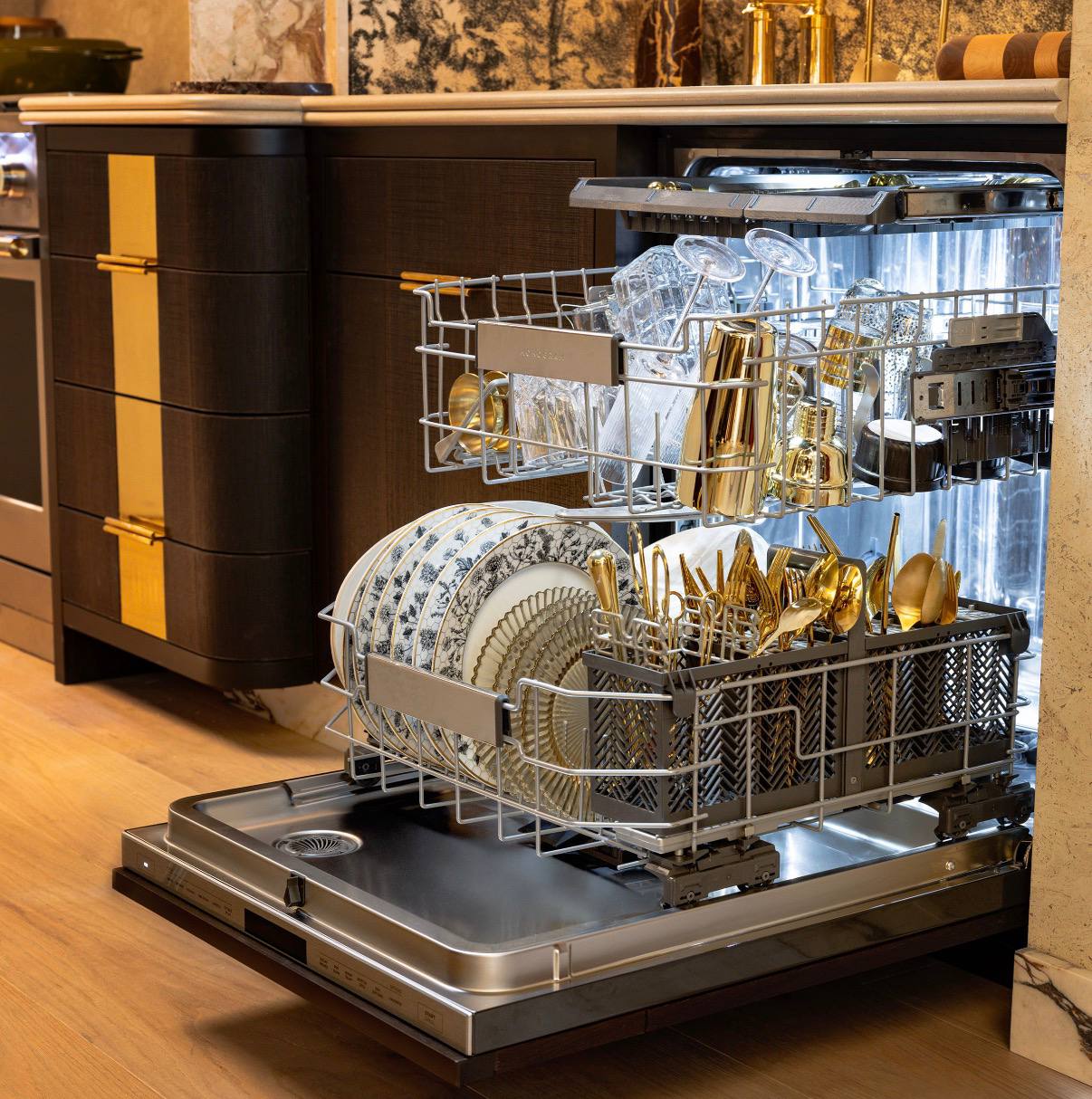Dishwasher rack pulled out showing dishware and utensils loaded inside